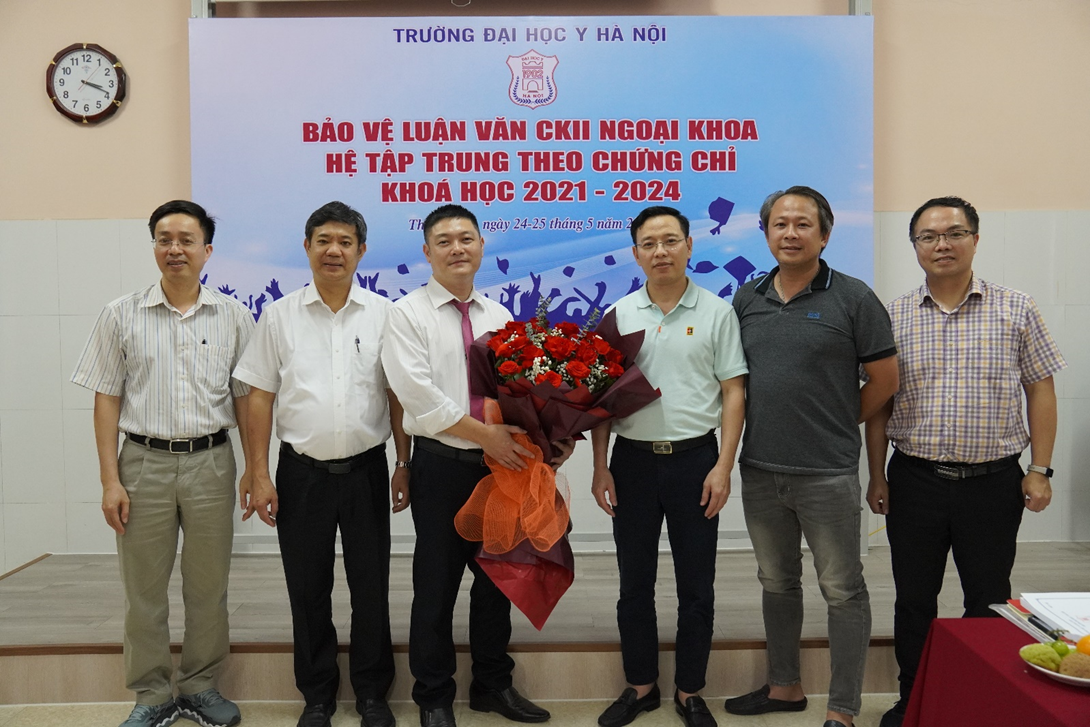 A group of men standing in front of a sign

Description automatically generated